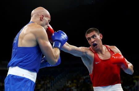 2016 Rio Olympics - Boxing - Final - Men's Heavy (91kg) Final Bout 220 - Riocentro - Pavilion 6 - Rio de Janeiro, Brazil - 15/08/2016. Evgeny Tishchenko (RUS) of Russia and Vassiliy Levit (KAZ) of Kazakhstan compete. REUTERS/Peter Cziborra