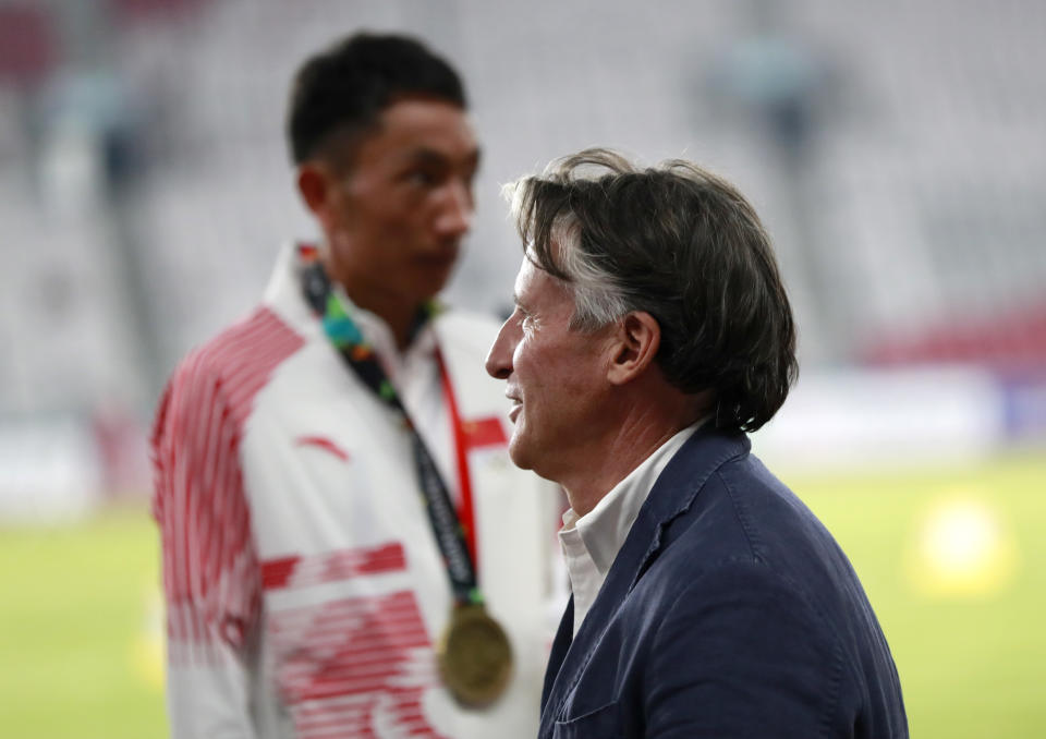 In this Saturday Aug. 25, 2018 photo, President of the International Association of Athletics Federations (IAAF) Sebastian Coe waits at the medal ceremony for the men's marathon during the athletics competition at the 18th Asian Games in Jakarta, Indonesia. Coe says China and Japan are the two most improved countries in athletics over the last six or seven years.(AP Photo/Bernat Armangue)