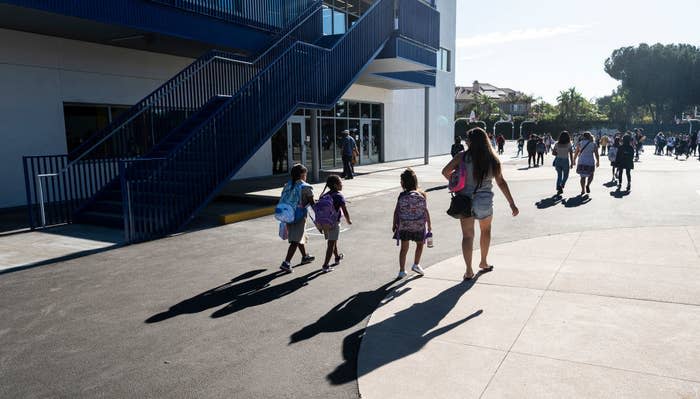 Parents walking with their kids from school