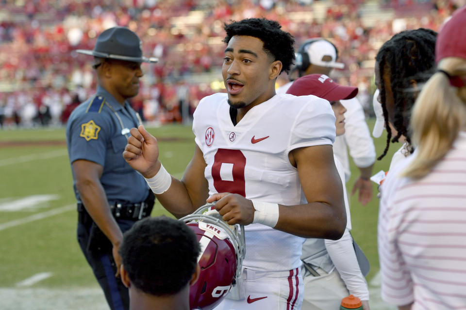 Alabama quarterback Bryce Young (9) talks to his team on the sidelines against Arkansas after leaving the game with an injury during the second half of an NCAA college football game Saturday, Oct. 1, 2022, in Fayetteville, Ark. (AP Photo/Michael Woods)