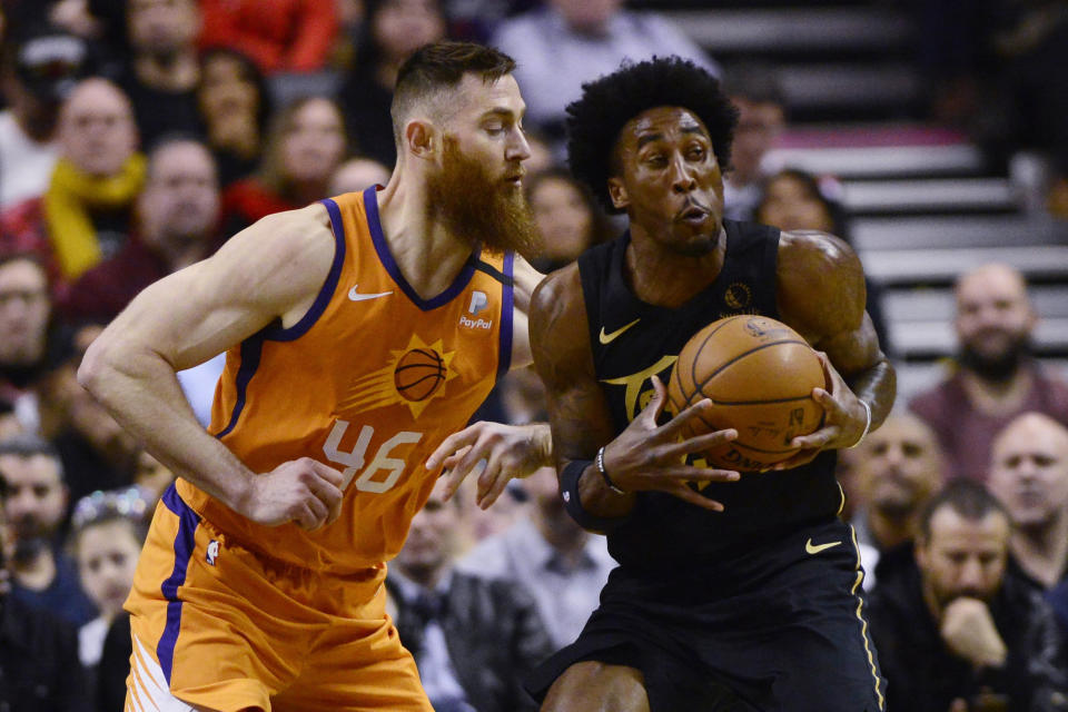 CORRECTS TORONTO PLAYER TO RONDAE HOLLIS-JEFFERSON, INSTEAD OF STANLEY JOHNSON - Phoenix Suns center Aron Baynes (46) defends against Toronto Raptors' Rondae Hollis-Jefferson during the first half of an NBA basketball game Friday, Feb. 21, 2020, in Toronto. (Frank Gunn/The Canadian Press via AP)