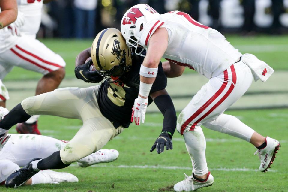 Wisconsin safety Collin Wilder (18) tackles Purdue wide receiver David Bell (3) during the fourth quarter of an NCAA college football game, Saturday, Oct. 23, 2021 at Ross-Ade Stadium in West Lafayette.