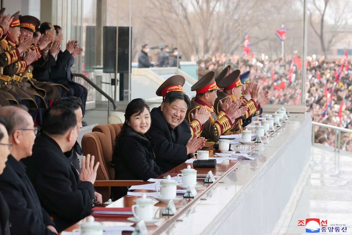 North Korean leader Kim Jong Un and his daughter watch a football match (via REUTERS)