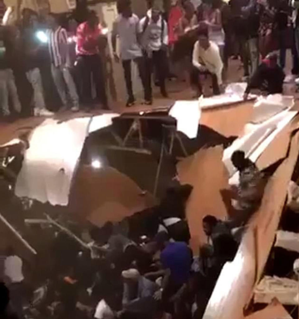 Stunned partygoers watch on as dozens fell through the giant hole at the house. Source: Twitter/ StevieW21