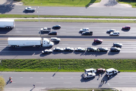 Law enforcement and fire personnel attend the scene where a serial bombing suspect died at the side of the highway near Round Rock, north of Austin, Texas, U.S. March 21, 2018, REUTERS/DroneBase