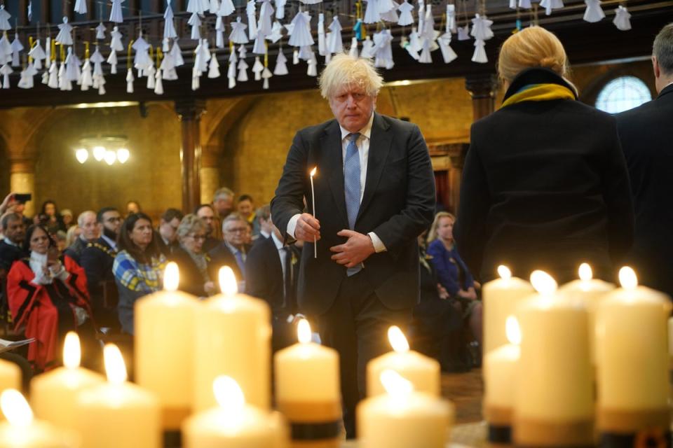 Former prime minister Boris Johnson lights one of 52 candles - one for each week of the war - during an ecumenical prayer service at the Ukrainian Catholic Cathedral in London, to mark the one year anniversary of the Russian invasion of Ukraine (PA)