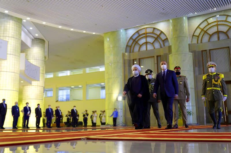 FILE PHOTO: Iranian President Hassan Rouhani welcomes Iraqi Prime Minister Mustafa al-Kadhimi as they wear protective masks, in Tehran