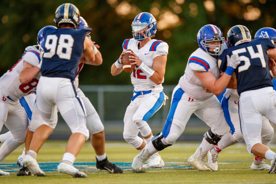 Liam Shepherd (12) of MUS drops back to pass against Arlington during the game between the Arlington Tigers and MUS Owls on Friday August, 19th 2022 in Arlington, Tn (Justin Ford/Special to the Commercial Appeal)