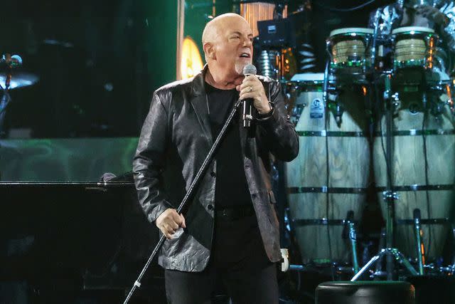 <p>Kevin Mazur/Getty </p> Billy Joel performs during his 100th show at Madison Square Garden on March 28.