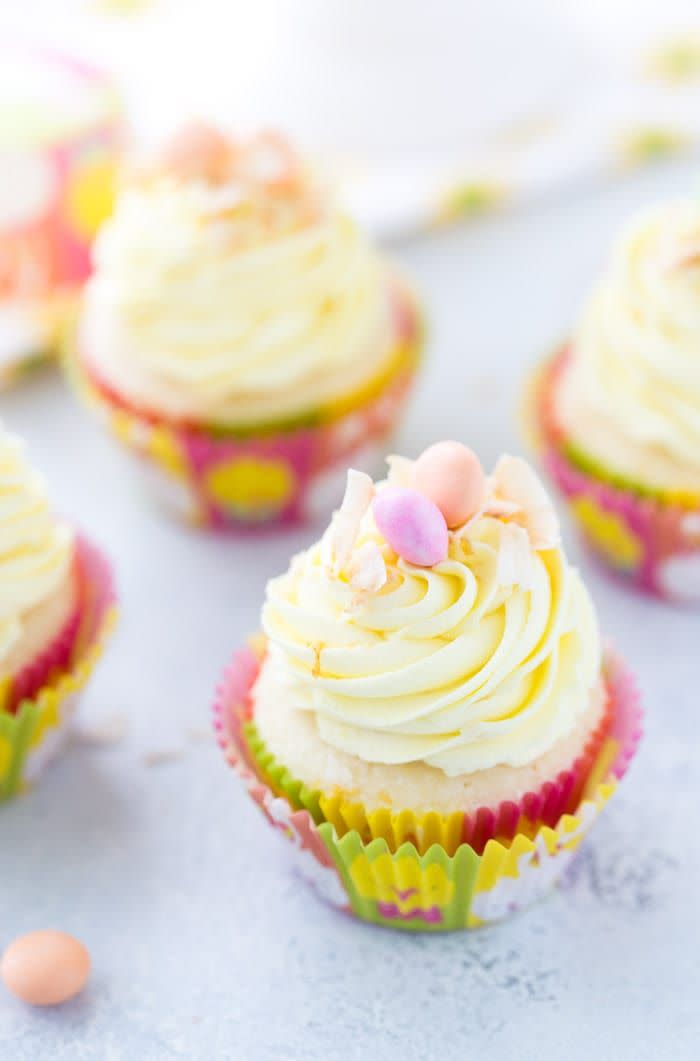 lemon cupcakes with frosting and two candy eggs