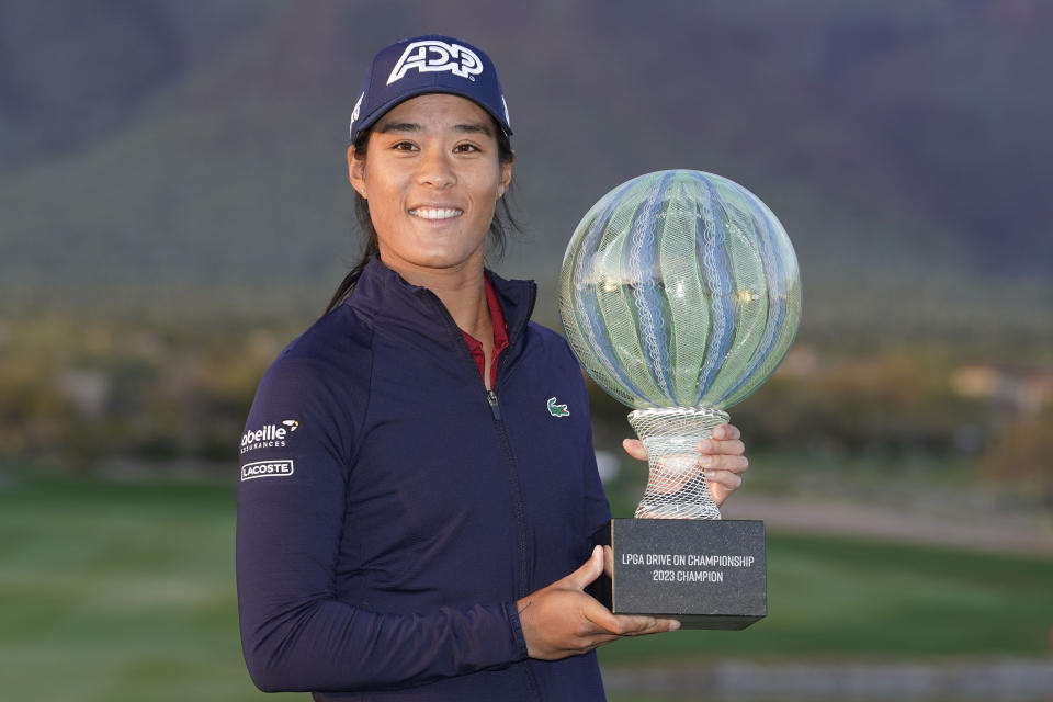 Celine Boutier holds up the Drive On Championship trophy after winning on a playoff hole during the final round of the Drive On Championship golf tournament, Sunday, March 26, 2023, in Gold Canyon, Ariz. (AP Photo/Darryl Webb)