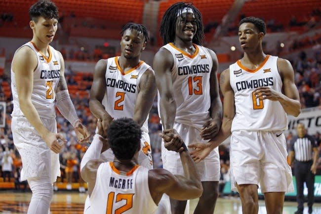 Oklahoma State's Lindy Waters III, left, Chris Harris Jr., Isaac Likekele and Avery Anderson III help up Cameron McGriff during a loss against Texas at Gallagher-Iba Arena in Stillwater on Jan. 15, 2020.