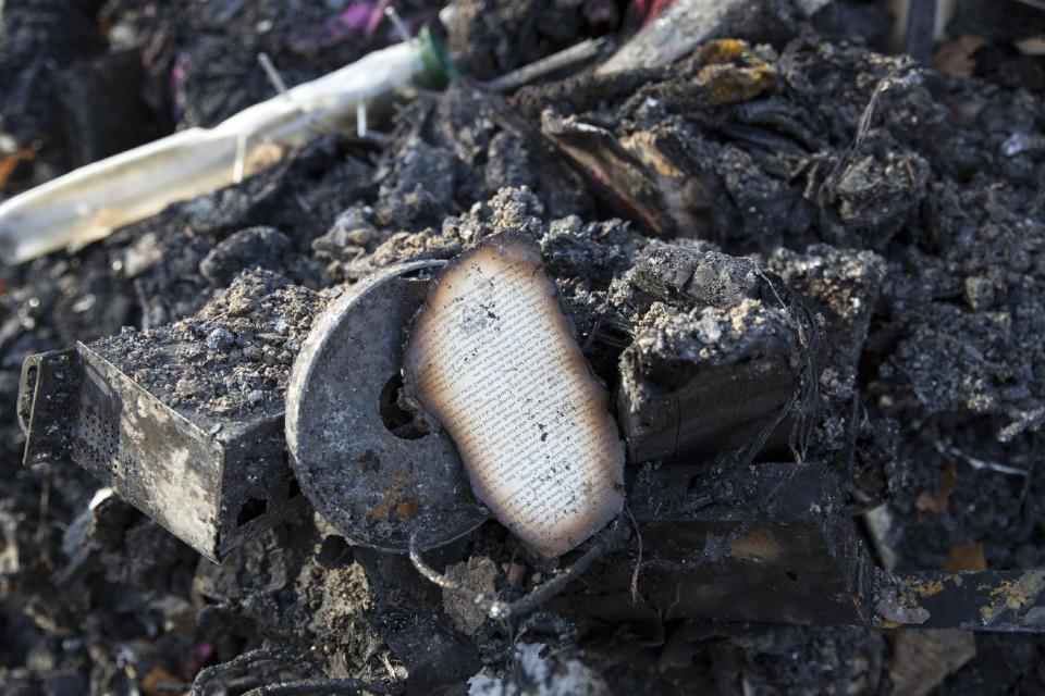 Charred debris of a home lies on the ground following a deadly house fire, Saturday, March 4, 2017, in Warwick, Mass. A mother and four children were killed when flames swept through their rural Massachusetts home early Saturday, fire officials said. Two other family members escaped the fire, which broke in the single-family house. (Kieran Kesner /The Boston Globe via AP, Pool)