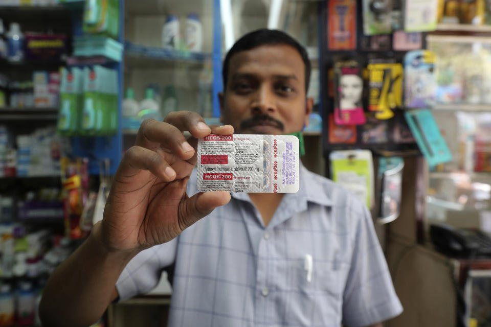 A chemist displays hydroxychloroquine tablets in Mumbai, India, Tuesday, May 19, 2020. President Donald Trump’s declaration that he was taking the antimalarial drug of dubious effectiveness to help fend off the coronavirus will be welcomed in India. Trump's previous endorsement of hydroxychloroquine catalyzed a tremendous shift in the South Asian country, spurring the world’s largest producer of the drug to make much more of it, prescribe it for front-line health workers treating cases of the coronavirus and deploy it as a diplomatic tool, despite mounting evidence against using the drug for COVID-19. (AP Photo/Rafiq Maqbool)