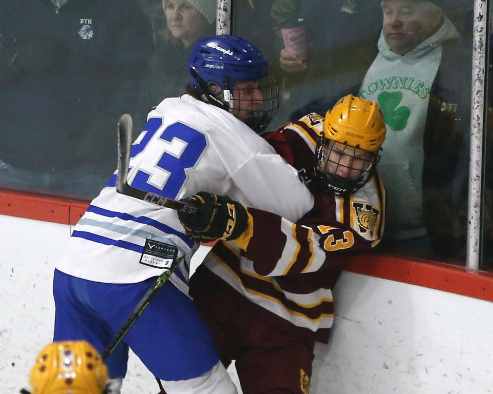 Braintree's Charlie DiMartino pins Weymouth's Jack Browning into the boards during first period action of their game in the Round of 32 game in the Division 1 state tournament at Zapustas Ice Arena in Randolph on Wednesday, March 1, 2023.