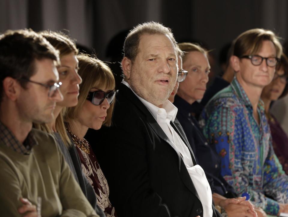 Harvey Weinstein, center, and Vogue Editor Anna Wintour, third left, watch the Marchesa Spring 2014 collection during Fashion Week in New York, Wednesday, Sept. 11, 2013. (AP Photo/Seth Wenig)