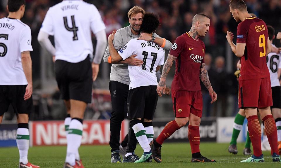 Jürgen Klopp celebrates with Mohamed Salah after Liverpool booked their place in the Champions League with victory in Rome.