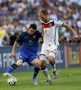 Argentina's Lionel Messi (L) fights for the ball with Germany's Benedikt Hoewedes during their 2014 World Cup final at the Maracana stadium in Rio de Janeiro July 13, 2014. REUTERS/Darren Staples