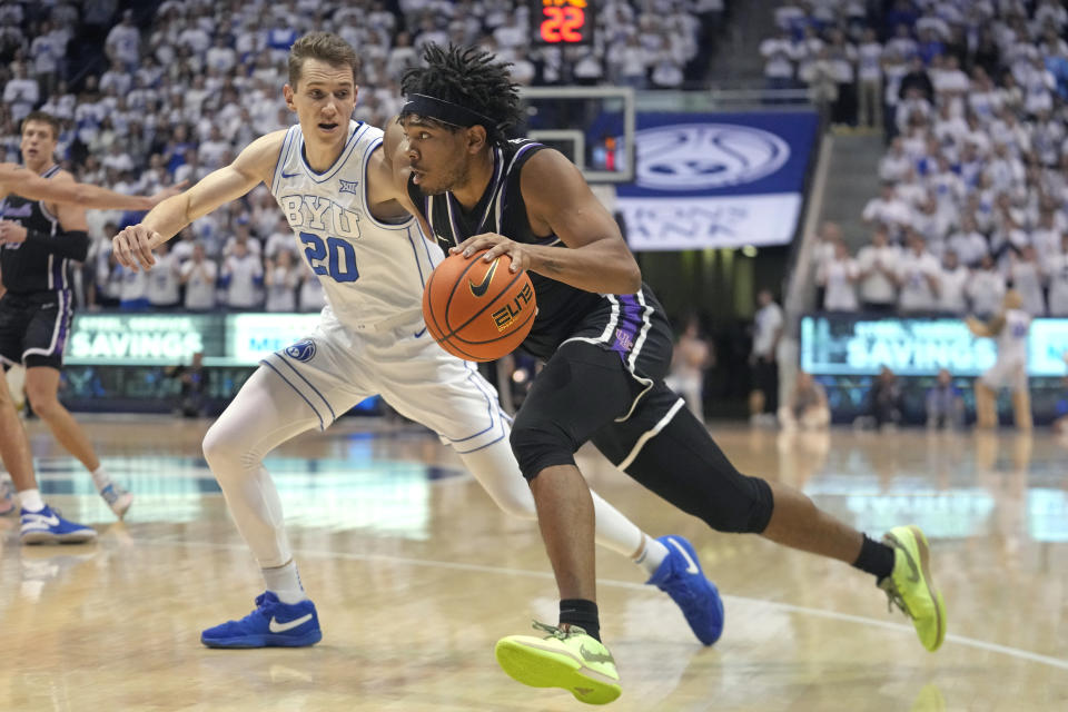 Evansville Aces guard Kenny Strawbridge Jr., right, drives as BYU guard Spencer Johnson (20) defends during the first half of an NCAA college basketball game Tuesday, Dec. 5, 2023, in Provo, Utah. (AP Photo/Rick Bowmer)