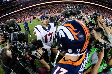 Oct 24, 2016; Denver, CO, USA; Houston Texans quarterback Brock Osweiler (17) and Denver Broncos quarterback Trevor Siemian (13) greet each other after the game at Sports Authority Field at Mile High. The Broncos won 27-9. Mandatory Credit: Isaiah J. Downing-USA TODAY Sports - RTX2QAJC