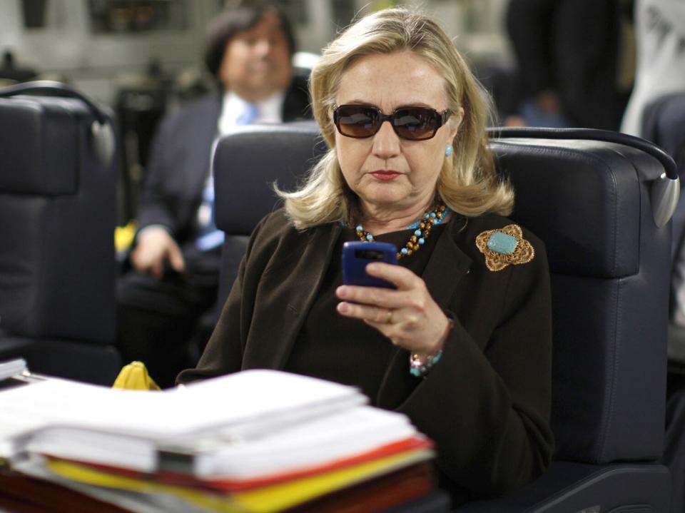 Hillary Rodham Clinton checks her Blackberry