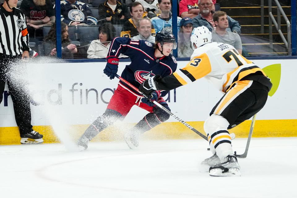Columbus Blue Jackets center Kent Johnson (91) skates around Pittsburgh Penguins defenseman Pierre-Olivier Joseph (73) during the third period of the NHL hockey game at Nationwide Arena on April 13, 2023. The Blue Jackets won 3-2 in overtime.