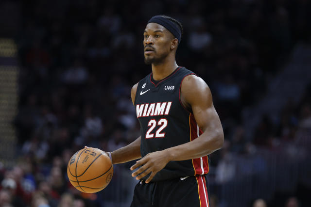 Miami's Jimmy Butler gives Dejoutne Murray a signed Heat jersey
