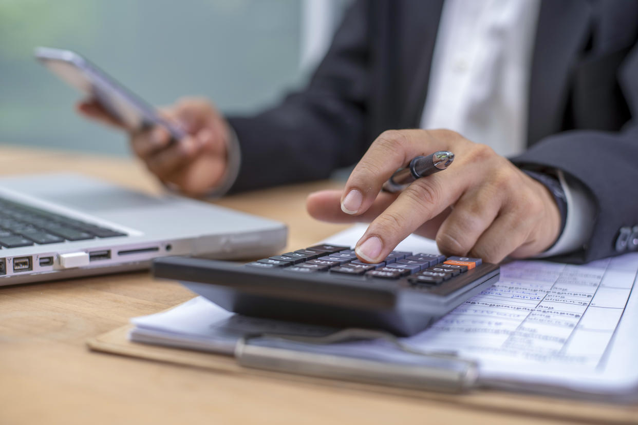 Business man calculating budget numbers, Invoices and financial adviser working.