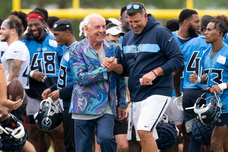 Professional wrestler Ric Flair shares a moment with Tennessee Titans head coach Mike Vrabel after a training camp practice at Saint Thomas Sports Park Thursday, July 28, 2022, in Nashville, Tenn. 