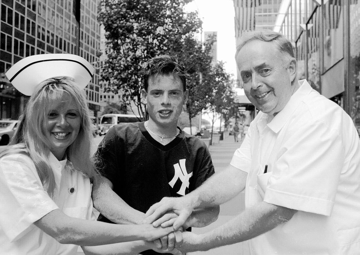 Hugh (R) and Patrica Brennan (L) both graduated as registered nurses from the Hopfer School of Nursing. Michael Brennan is pictured at center. 