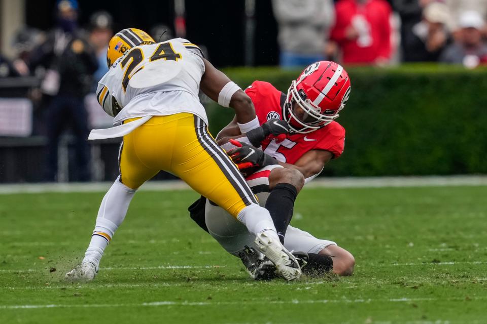 Georgia wide receiver Adonai Mitchell (5) catches a pass against Missouri defensive back Allie Green IV (24) during a game at Sanford Stadium in Athens, Ga.