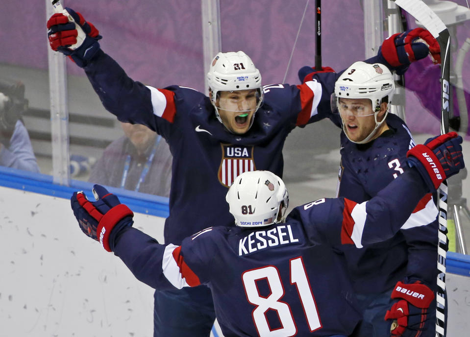 USA forward James van Riemsdyk, defenseman Cam Fowler and USA forward Phil Kessel celebrate a goal by Fowler in the second period of a men's ice hockey game against Russia at the 2014 Winter Olympics, Saturday, Feb. 15, 2014, in Sochi, Russia. (AP Photo/Petr David Josek)