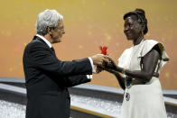 Festival president Robert Cicutto, left, presents director Alice Diop with the Lion of the Future - "Luigi De Laurentiis" Venice Award for a Debut Film for 'Saint Omar' at the closing ceremony of the 79th edition of the Venice Film Festival in Venice, Italy, Saturday, Sept. 10, 2022. (AP Photo/Domenico Stinellis)