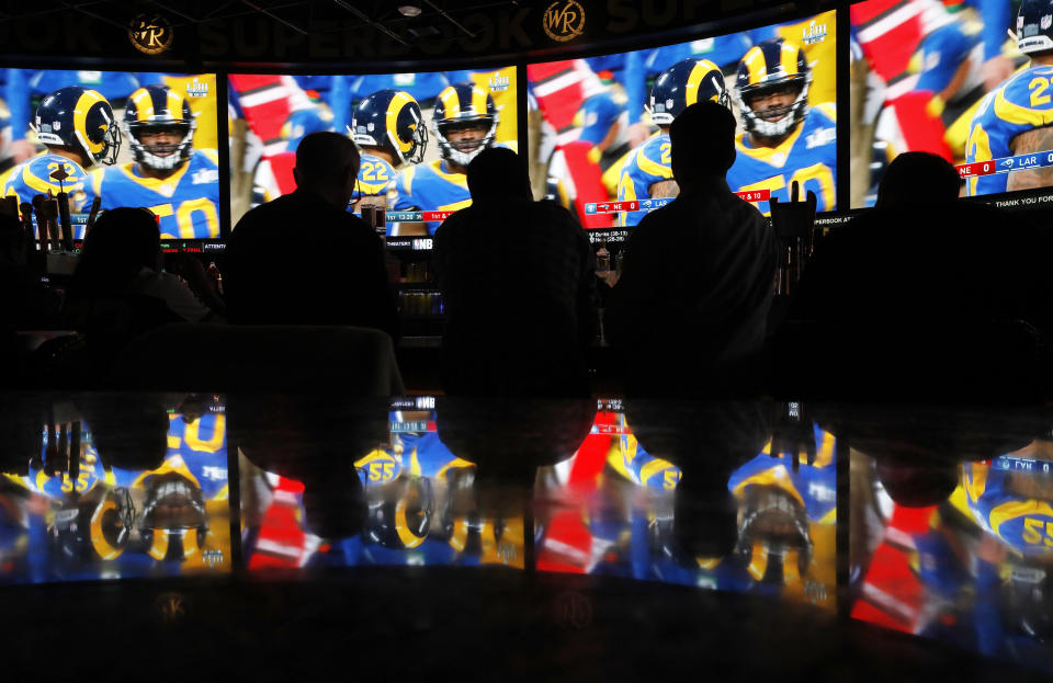 People watch Super Bowl LIII at the Westgate Superbook sports book, Sunday, Feb. 3, 2019, in Las Vegas. (AP Photo/John Locher)