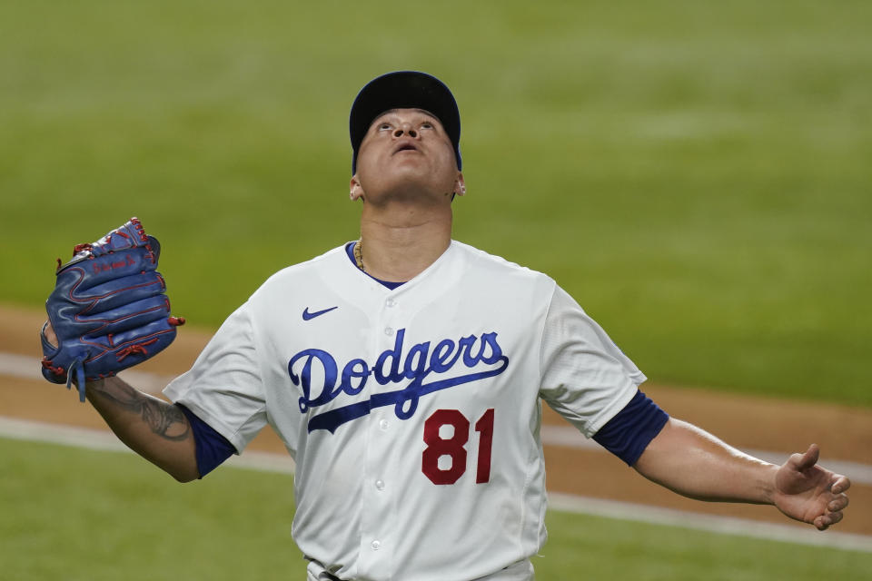 Los Angeles Dodgers starting pitcher Victor Gonzalez looks up as he leaves the game during fourth inning against the Tampa Bay Rays in Game 2 of the baseball World Series Wednesday, Oct. 21, 2020, in Arlington, Texas. (AP Photo/Eric Gay)