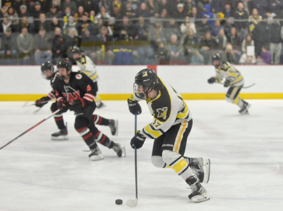Nauset's Logan Poulin moves the puck down the ice in third period action during a March 8th game.