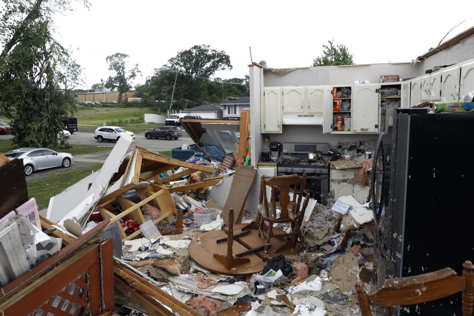 Household items litter the floor of a severely damaged house after a tornado passed through the area on Monday, June 21, 2021, in Woodridge, Ill. (AP Photo/Shafkat Anowar)