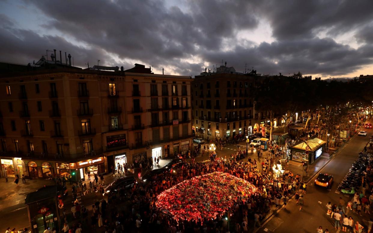 People gather at an impromptu memorial where a van crashed into pedestrians at Las Ramblas in Barcelona - REUTERS