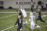 BYU wide receiver Gunner Romney (18) leaps to catch a pass over Navy defensive back Cameron Kinley during the second half of an NCAA college football game, Monday, Sept. 7, 2020, in Annapolis, Md. (AP Photo/Tommy Gilligan)