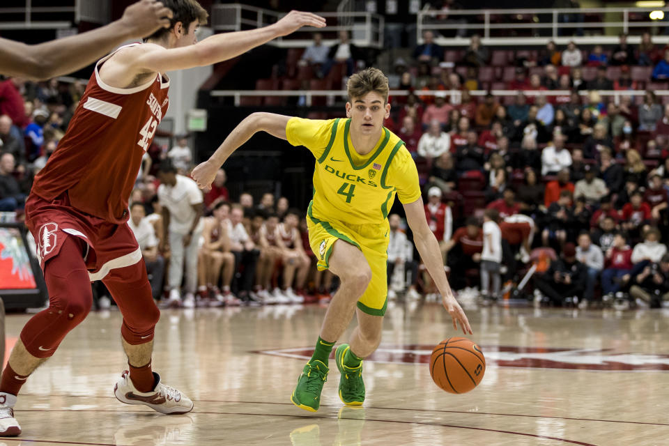 Oregon guard Brennan Rigsby (4) drives past Stanford forward Maxime Raynaud during the second half of an NCAA college basketball game in Stanford, Calif., Saturday, Jan. 21, 2023. Stanford won 71-64. (AP Photo/John Hefti)
