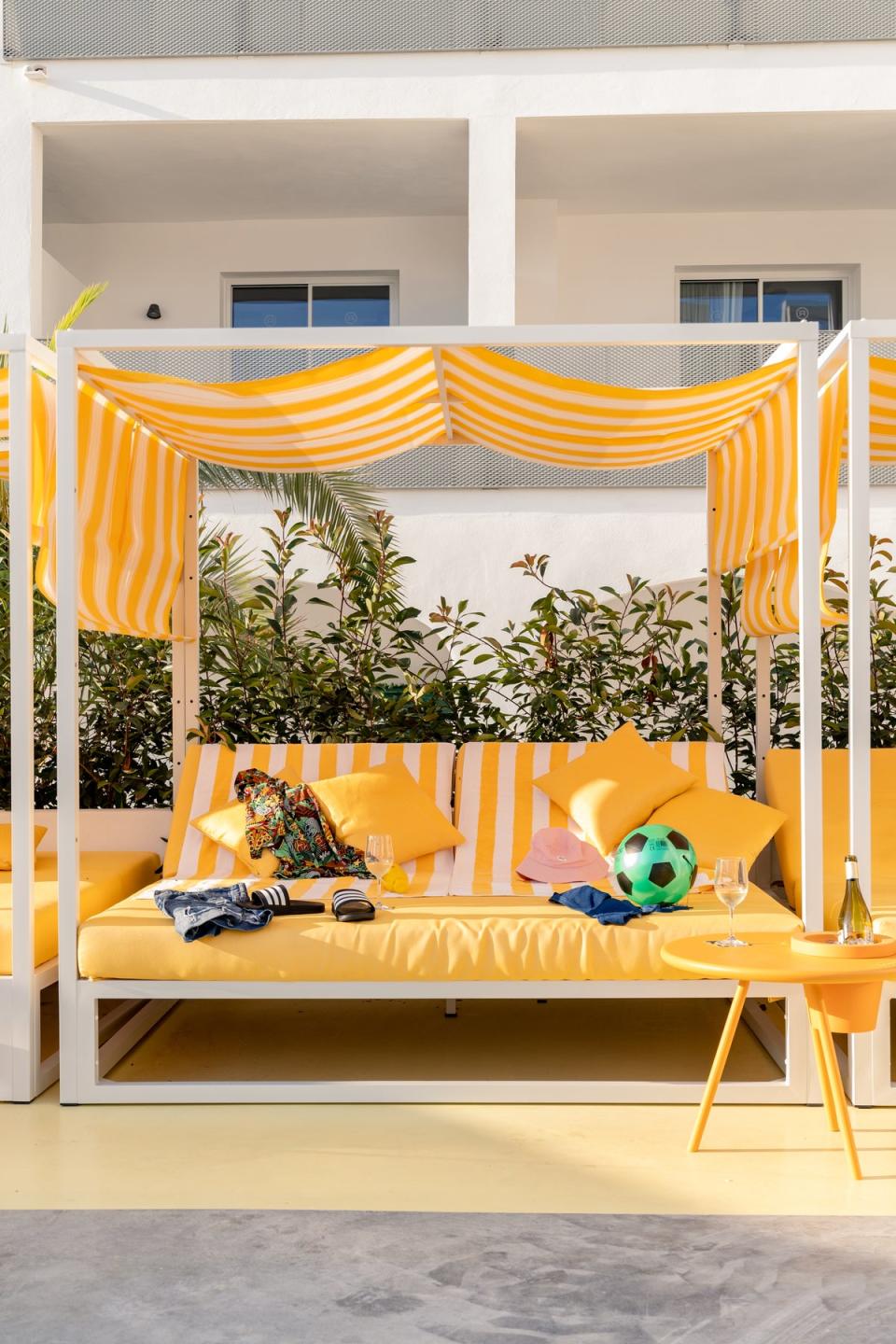 A Love Island-style yellow day beds next to the pool (Ryans)