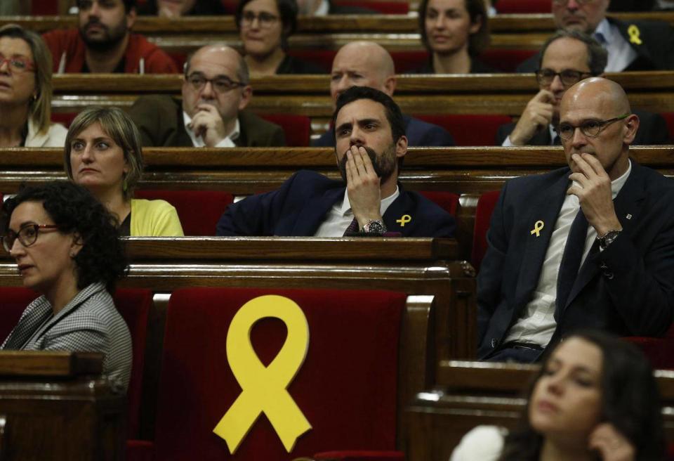 Yellow ribbons marking the seats of Catalan parliamentarians who could not attend the opening session of the body because they are in jail in Madrid (AP)