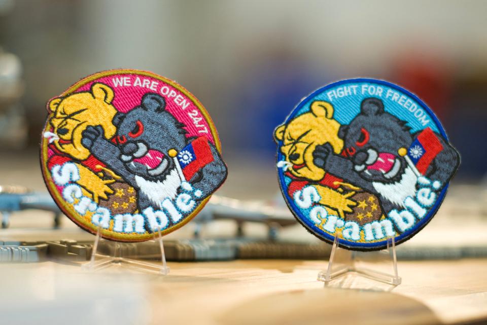 This picture shows patches depicting a Formosan black bear holding a Taiwanese flag punching Winnie-the-Pooh at a shop in Taoyuan on April 11, 2023.