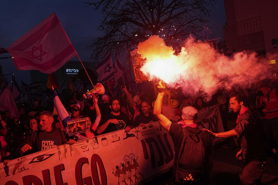 Israelis protest against plans by Prime Minister Benjamin Netanyahu's government to overhaul the judicial system, in Tel Aviv, Israel, Saturday, April 8, 2023. (AP Photo/Ariel Schalit)