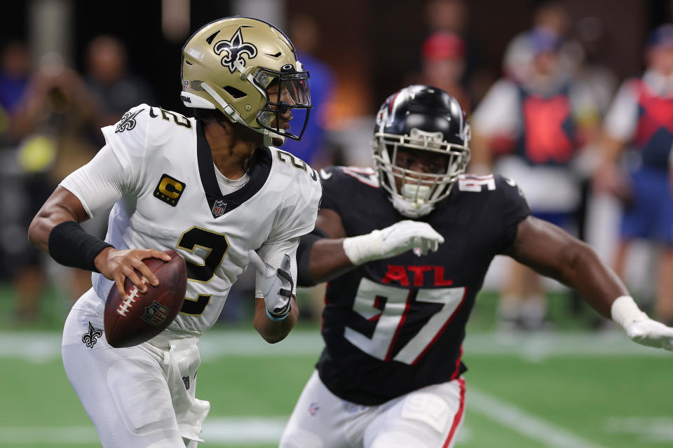 ATLANTA, GEORGIA - SEPTEMBER 11: Quarterback Jameis Winston #2 of the New Orleans Saints scrambles while pressured by defensive end Grady Jarrett #97 of the Atlanta Falcons in the first half at Mercedes-Benz Stadium on September 11, 2022 in Atlanta, Georgia. (Photo by Kevin C. Cox/Getty Images)