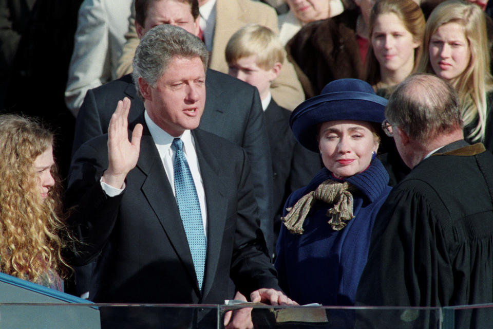 Bill Clinton is sworn-in as the 42nd President of the United States by U.S. Chief of Justice Honorable William H. Rehnquist (R) as his wife Hillary and his daughter Chelsea (L) look on in Washington, DC on January 20, 1993. REUTERS/Jim Bourg