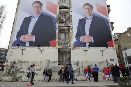 People pass posters of Serbian Prime Minister Aleksandar Vucic, in Novi Sad, Serbia March 18, 2017. Picture taken March 18, 2017. REUTERS/Marko Djurica