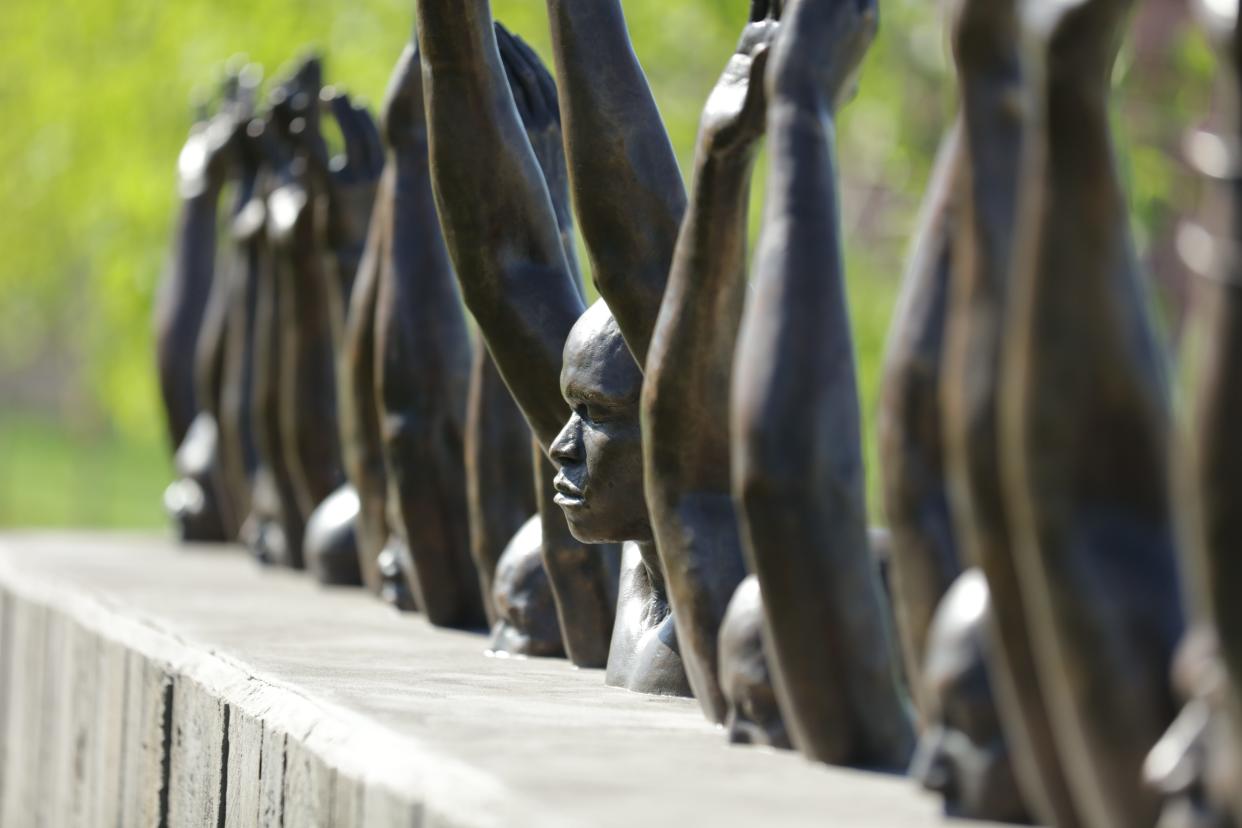 This is a sculpture by Hank Willis Thomas, Raise Up, on the grounds of the Memorial for Peace and Justice in Montgomery, Ala.