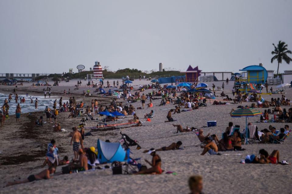 People relax on the beach in Miami Beach in Florida amid the coronavirus pandemic.