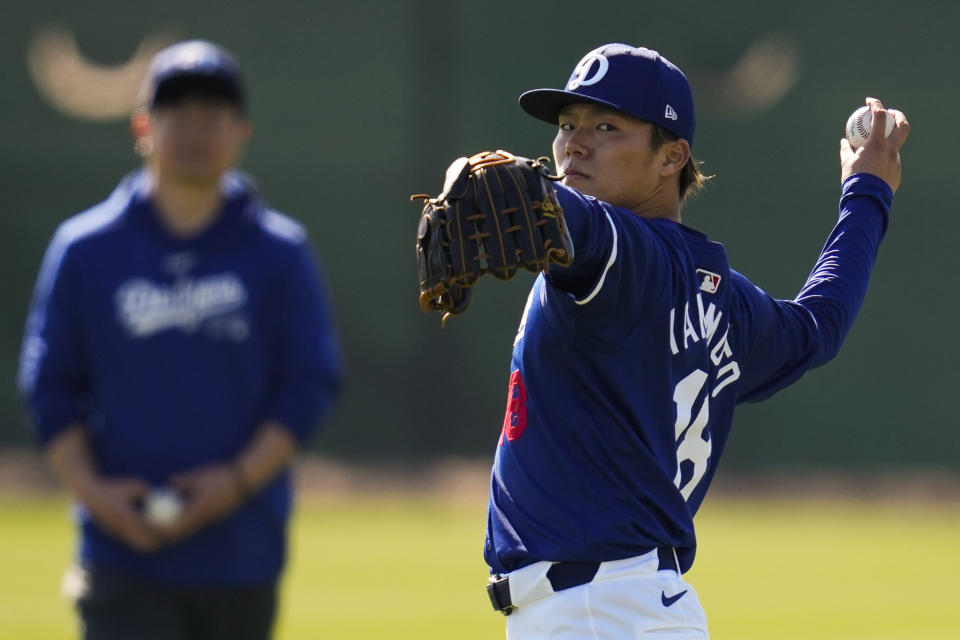 Los Angeles Dodgers starting pitcher Yoshinobu Yamamoto throws during spring training baseball workouts at Camelback Ranch in Phoenix, Tuesday, Feb. 13, 2024. (AP Photo/Ashley Landis)